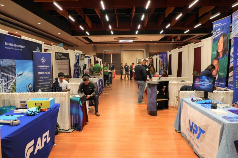 View down the row of booths at an in-person career fair