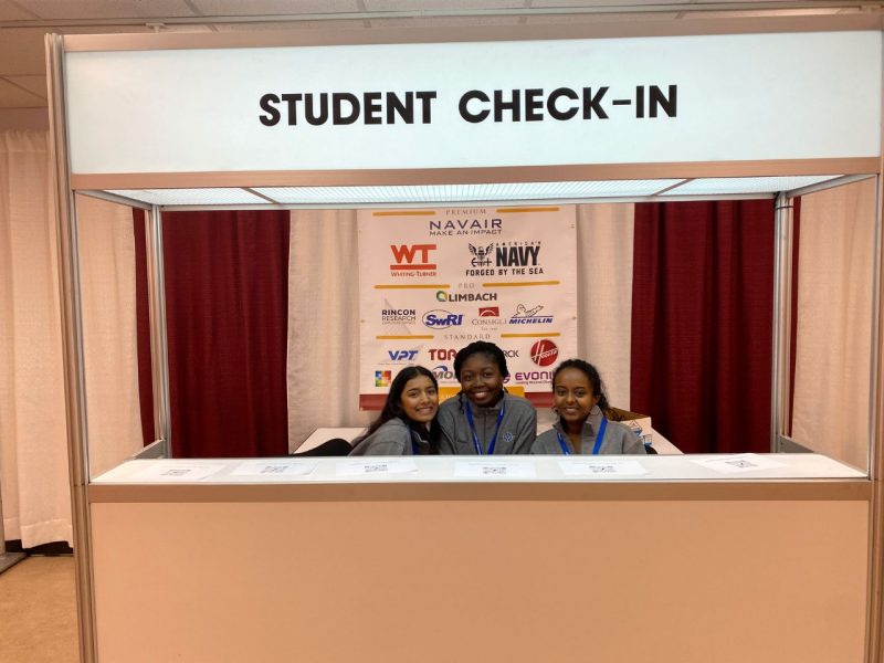 students volunteering at the student check-in booth
